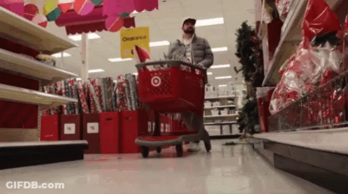 Man Pushing Shopping Cart In Clearance Store GIF
