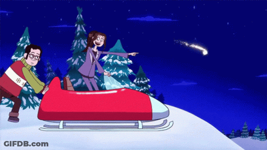 Man Pushing Snowmobile With Woman Toward A Slope GIF