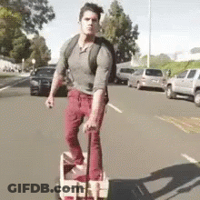 Man Pushing Wagon Down Street GIF