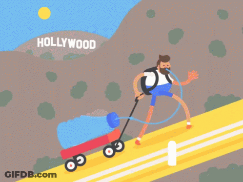 Man Pushing Wagon Up Hill In Hollywood GIF