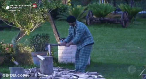 Man Pushing Wheelbarrow Full Of Logs GIF