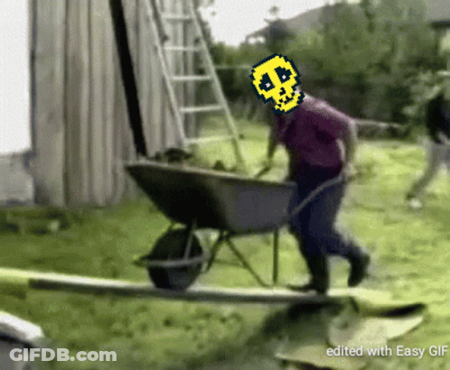 Man Pushing Wheelbarrow With Pixelated Skull On Head GIF