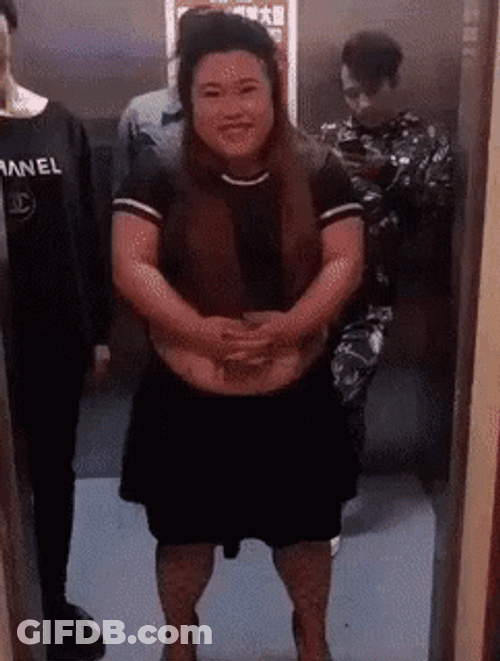 Man Pushing Woman Out Of Elevator GIF