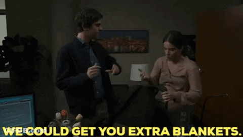 Man Putting Blanket On Woman: We Could Get You Extra Blankets GIF