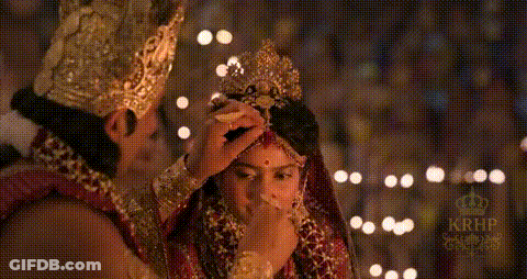 Man Putting Crown On Bride's Head GIF