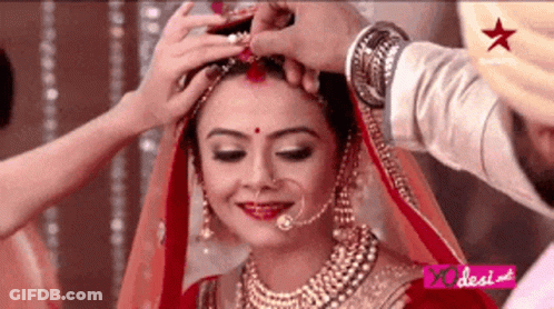 Man Putting Flower In Woman's Hair GIF