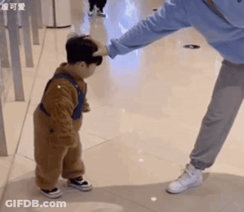 Man Putting Hand On Little Boy's Head GIF