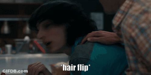Man Putting Hand On Woman's Shoulder Saying Hair Flip GIF