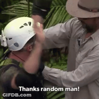 Man Putting Helmet On Another Man GIF