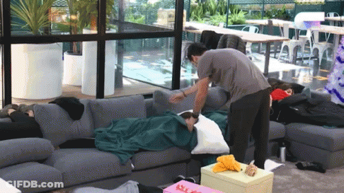 Man Putting Pillow On Woman GIF