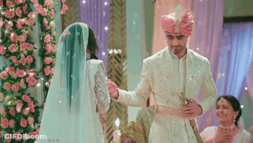 Man Putting Ring On Woman's Finger With The Pursuit Of Love GIF