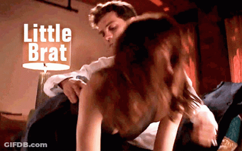 Man Putting Woman On Bed Saying Little Brat GIF
