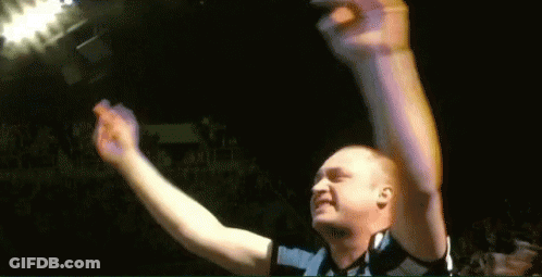 Man Raising Arms In Dark Room GIF