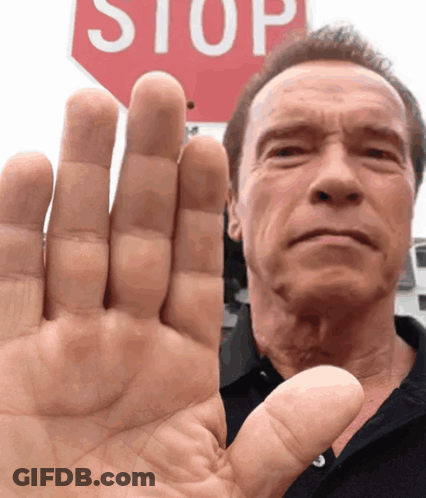 Man Raising Hand At Red Stop Sign GIF