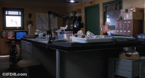 Man Reaching Hand Towards Desk GIF