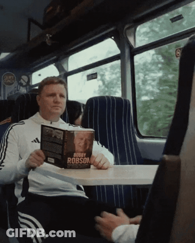 Man Reading Bobby Robson Book GIF