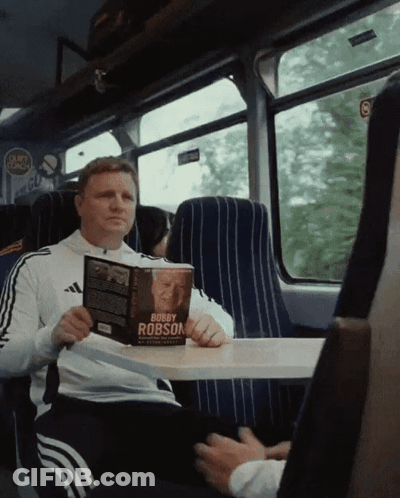 Man Reading Bobby Robson Book GIF