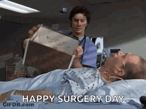 Man Reading In Hospital Bed, Doctor Holding Box GIF