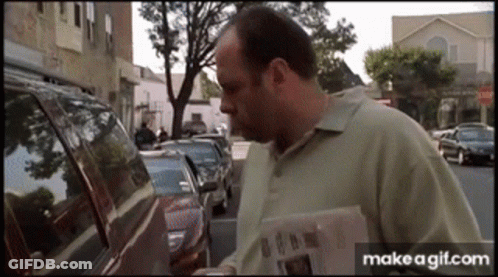 Man Reading Newspaper In Front Of Car GIF