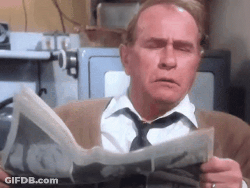 Man Reading Newspaper With Eyes Closed GIF