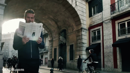 Man Reading Newspaper Woman Riding Bike GIF
