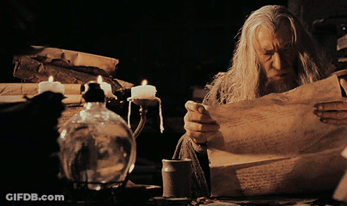 Man Reading Paper With Candles GIF