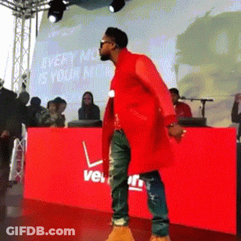 Man Red Coat Dancing By Red Verizon Sign GIF