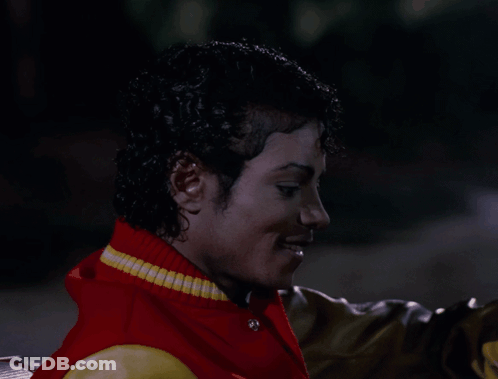 Man Red Yellow Varsity Jacket Looking At Camera GIF
