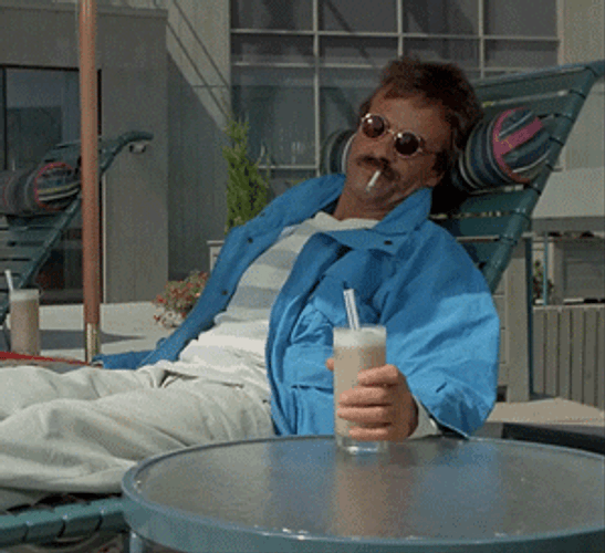 Man Relaxing While Holding A Drink GIF