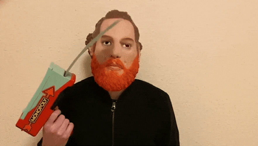 Man Releasing Monopoly Money Through Gun GIF
