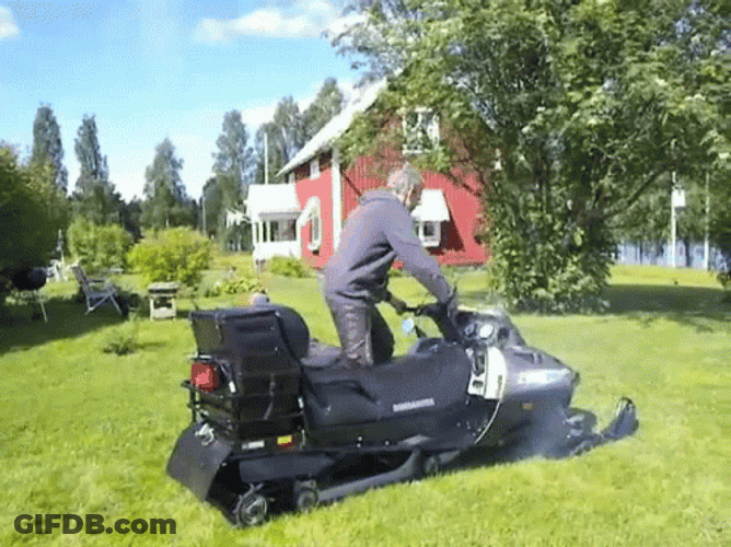 Man Riding A Snowmobile On The Grass GIF