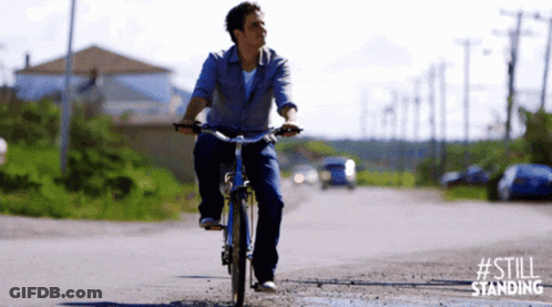 Man Riding Bike Down Dirt Road GIF