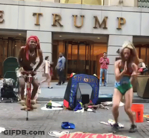 Man Riding Bike In Front Of Trump Building GIF