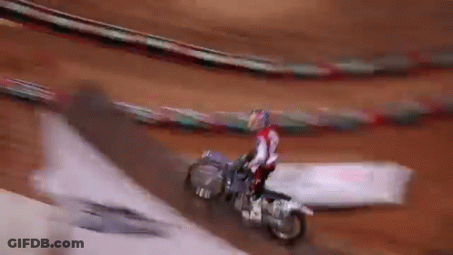 Man Riding Bike In Front Of Zamx Sign GIF