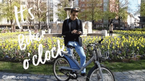 Man Riding Bike In Park Saying Its Time O Clock GIF