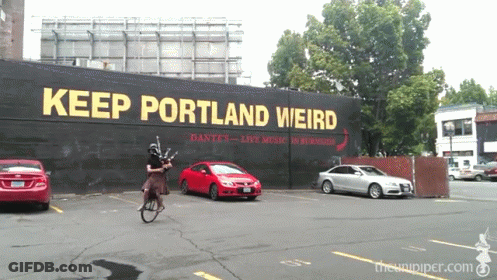 Man Riding Bike Keep Portland Weird Sign GIF