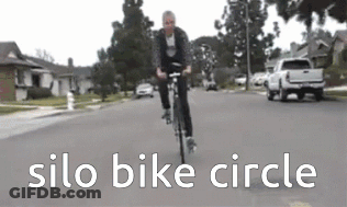 Man Riding Bike Under Silo Bike Circle GIF