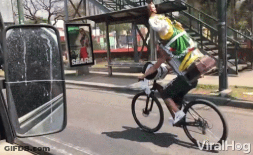 Man Riding Bike With Sears Ad GIF
