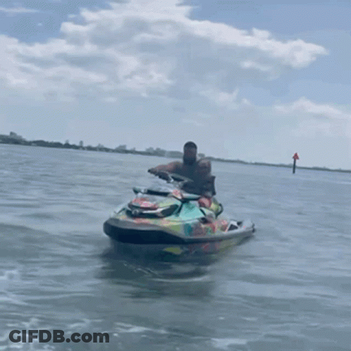 Man Riding Colorful Jet Ski In Water GIF