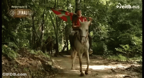 Man Riding Donkey Holding Eitb.eus Flag GIF