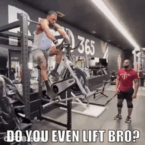 Man Riding Exercise Bike In Gym While Man Watches GIF