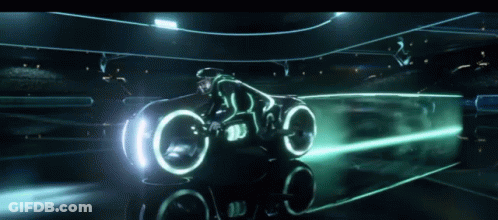 Man Riding Futuristic Motorcycle With Glowing Lights GIF