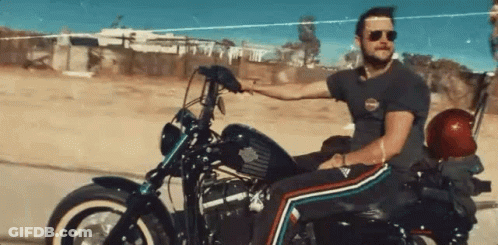 Man Riding Harley Davidson Motorcycle On Dirt Road GIF
