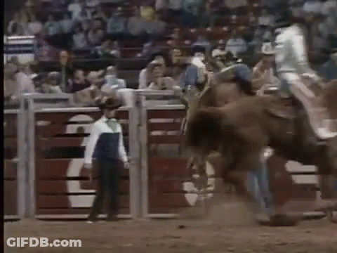 Man Riding Horse In Rodeo With Man Behind GIF