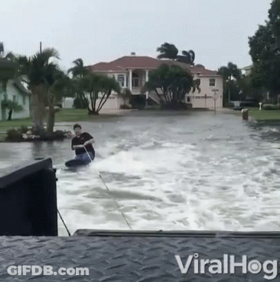 Man Riding Jet Ski In Flood GIF