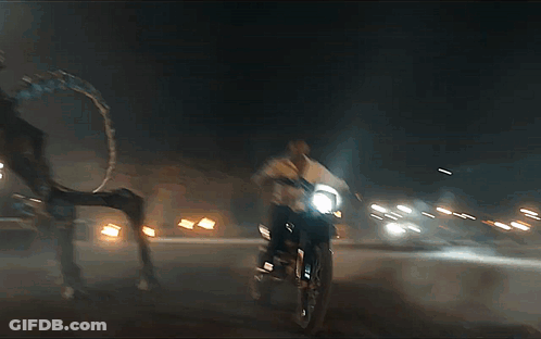 Man Riding Motorcycle At Night With Headlight GIF