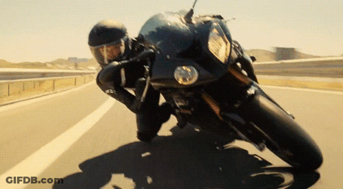 Man Riding Motorcycle Down Highway GIF