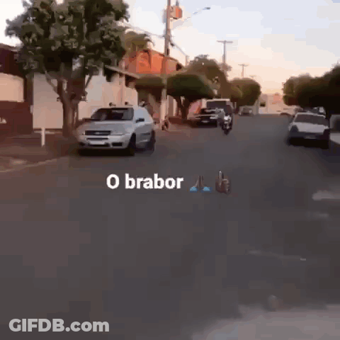 Man Riding Motorcycle Down Street GIF
