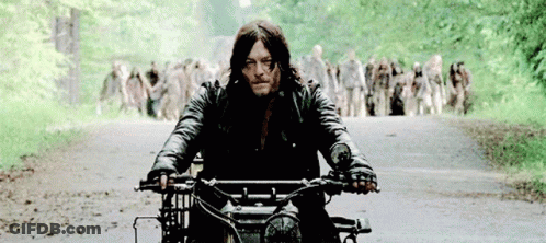 Man Riding Motorcycle From Zombie Crowd GIF