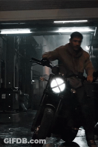 Man Riding Motorcycle In Dark Alley GIF